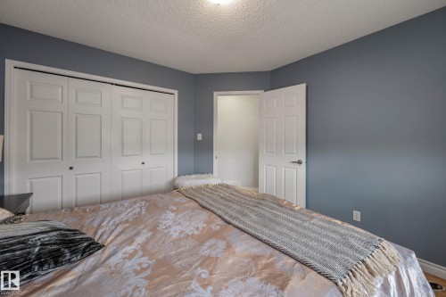 Room featuring gray walls, white baseboards, and a white paneled door - 9113 166 Avenue Nw, Edmonton, AB - Indoor Photo Showing Bedroom