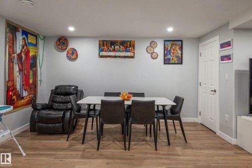 Recessed lighting illuminates this versatile space featuring wood-finish flooring and light gray walls - 9113 166 Avenue Nw, Edmonton, AB - Indoor