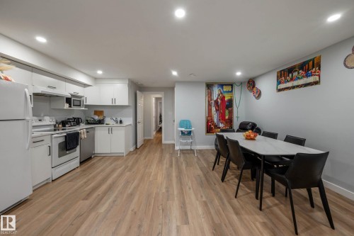 Open-concept kitchen and dining area featuring light wood-finish flooring - 9113 166 Avenue Nw, Edmonton, AB - Indoor