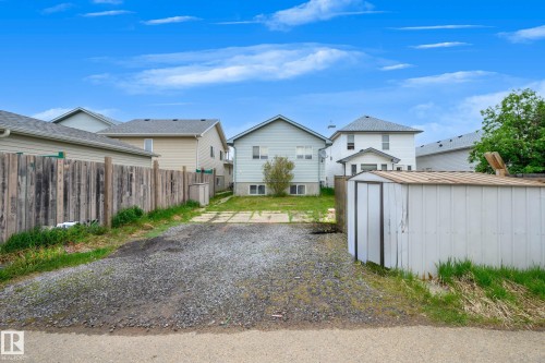 Gravel driveway leading to the property with a detached storage shed - 9113 166 Avenue Nw, Edmonton, AB - Outdoor