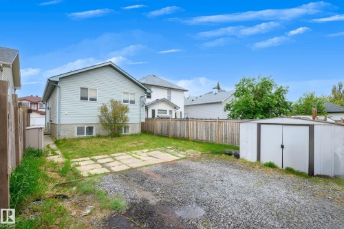 Exterior featuring light blue horizontal siding and a gray asphalt shingle roof - 9113 166 Avenue Nw, Edmonton, AB - Outdoor
