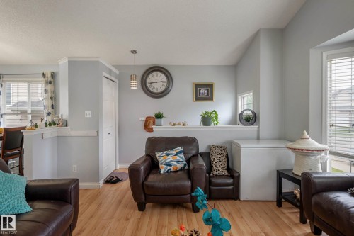 Open-concept living area featuring light wood-finish flooring, light gray wall paint, and white trim - 9113 166 Avenue Nw, Edmonton, AB - Indoor Photo Showing Living Room