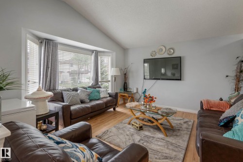 Living area featuring a vaulted ceiling and wood-finish flooring - 9113 166 Avenue Nw, Edmonton, AB - Indoor Photo Showing Living Room