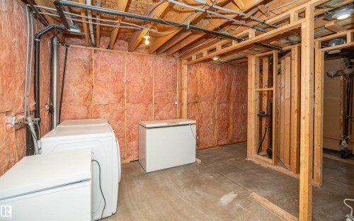 Unfinished basement featuring exposed wood framing and insulation, providing an expansive area for customization - 5116 51 Avenue, Pickardville, AB - Indoor Photo Showing Laundry Room