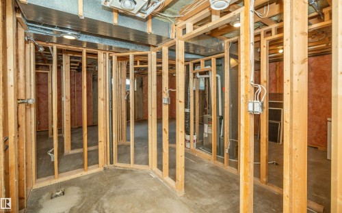 Unfinished basement with visible wood framing, concrete flooring, exposed ductwork, electrical wiring, and plumbing - 5116 51 Avenue, Pickardville, AB - Indoor Photo Showing Other Room