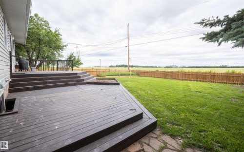 Multi-level outdoor deck with built-in steps and dark wood-finish decking - 5116 51 Avenue, Pickardville, AB - Outdoor With Deck Patio Veranda