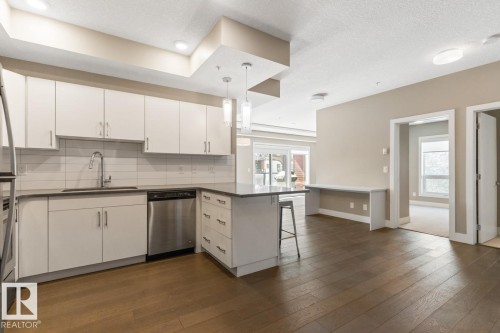Looking At The Kitchen & Into Living Room Space. - #203 10006 83 Av Nw, Edmonton, AB - Indoor Photo Showing Kitchen With Stainless Steel Kitchen