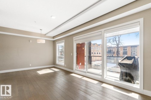 South Facing Door To Balcony With Gas Hook-Up. - #203 10006 83 Av Nw, Edmonton, AB - Indoor With Fireplace