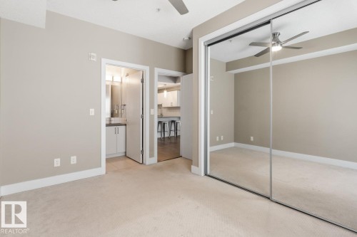 Primary Bedroom With Mirrored Closet Doors. - #203 10006 83 Av Nw, Edmonton, AB - Indoor Photo Showing Other Room