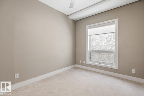 Second Bedroom With Nice Window, Ceiling Fan & Mirrored Closet. - #203 10006 83 Av Nw, Edmonton, AB - Indoor Photo Showing Other Room