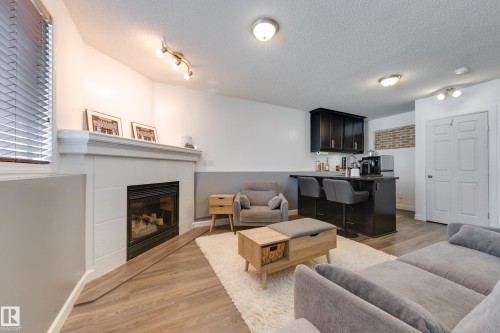 7904 13 Avenue Sw, Edmonton, AB - Indoor Photo Showing Living Room With Fireplace