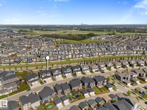 Aerial perspective highlighting a residential development with a consistent architectural style - 6875 Evans Wynd Nw, Edmonton, AB - Outdoor With View