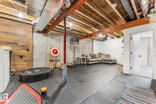 Versatile lower level with exposed wooden ceiling joists and concrete foundation walls - 6875 Evans Wynd Nw, Edmonton, AB - Indoor Photo Showing Basement