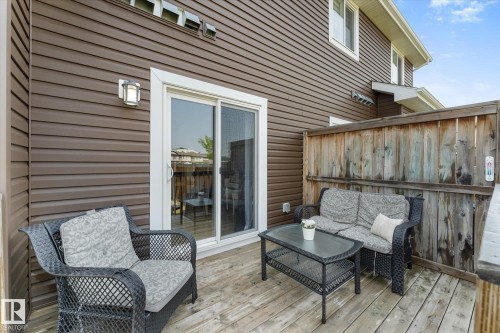 Private wooden deck with a sliding glass door entry - 6875 Evans Wynd Nw, Edmonton, AB - Outdoor With Deck Patio Veranda With Exterior