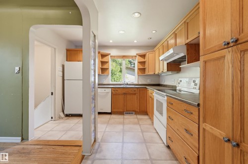 Kitchen featuring wood cabinetry, recessed lighting, and tile flooring - 7754 80 Avenue Nw, Edmonton, AB - Indoor Photo Showing Kitchen