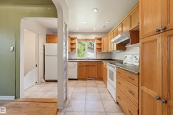 Kitchen featuring wood cabinetry, recessed lighting, and tile flooring - 