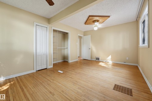 Room featuring wood-finish flooring, neutral wall tones, and white trim - 7754 80 Avenue Nw, Edmonton, AB - Indoor Photo Showing Other Room