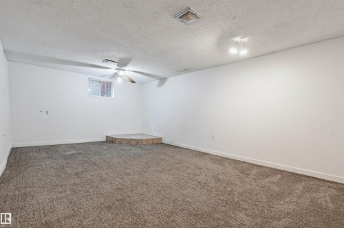 Carpeted room featuring a ceiling fan, recessed lighting, and a raised platform - 7754 80 Avenue Nw, Edmonton, AB - Indoor Photo Showing Other Room