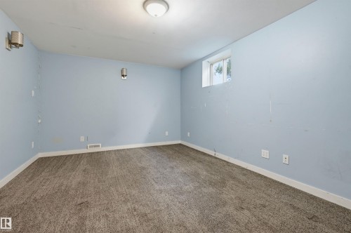 Room with light blue walls, gray carpet, white baseboards, and a window - 7754 80 Avenue Nw, Edmonton, AB - Indoor Photo Showing Other Room