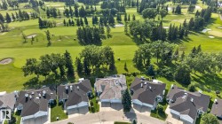 Aerial perspective showcasing properties bordering a golf course - 