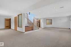 Spacious lower level featuring light-toned carpet flooring and recessed lighting - 