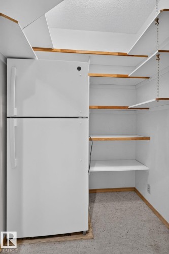 White top-freezer refrigerator with integrated shelving - 120 Ironwood Place Nw, Edmonton, AB - Indoor