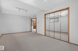 Spacious room featuring light-toned carpet flooring and white painted walls - 