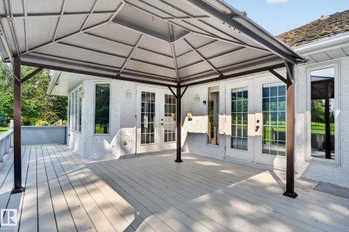 Expansive outdoor deck featuring a gazebo, white wood-finish flooring, and multiple glass-paned doors leading into the property - 120 Ironwood Place Nw, Edmonton, AB - Outdoor With Deck Patio Veranda