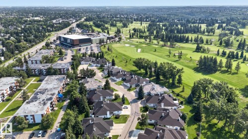 Expansive aerial perspective showcasing residential properties bordering a golf course - 120 Ironwood Place Nw, Edmonton, AB - Outdoor With View