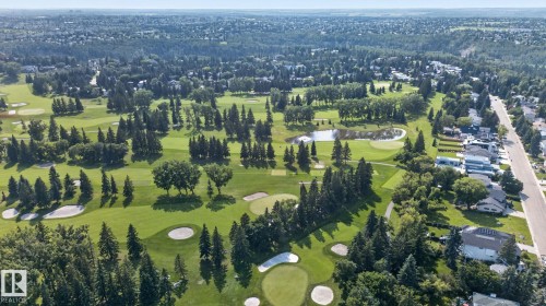 Expansive golf course and surrounding residential area featuring mature trees and a tranquil pond - 120 Ironwood Place Nw, Edmonton, AB - Outdoor With View