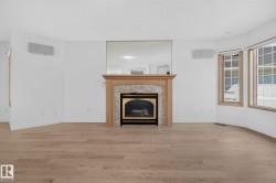 Fireplace with a natural wood mantel and stone surround - 