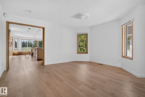 Spacious interior room with light wood-finish flooring and white walls - 120 Ironwood Place Nw, Edmonton, AB - Indoor Photo Showing Other Room