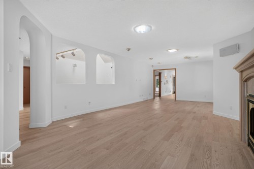 Expansive interior space featuring wood-finish flooring, recessed lighting, and a skylight - 120 Ironwood Place Nw, Edmonton, AB - Indoor Photo Showing Other Room