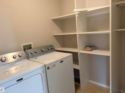 Dedicated laundry area featuring a washer and dryer setup - 