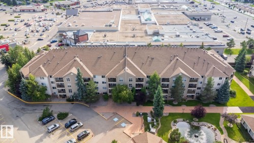 Multi-story residential building with private balconies and a shingled roof - #209 8912 156 St Nw, Edmonton, AB -  With View