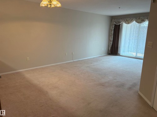 Spacious room with neutral wall tones and beige carpeting - #209 8912 156 St Nw, Edmonton, AB - Indoor Photo Showing Other Room