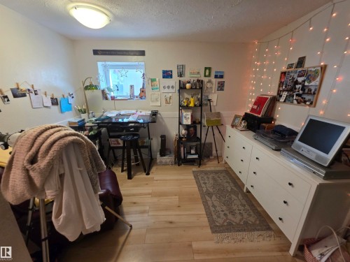 Light wood-finish flooring with white baseboards and walls - 38 Greenwood Drive, Spruce Grove, AB - Indoor Photo Showing Other Room
