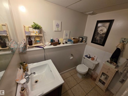 Bathroom featuring a single vanity with chrome faucet, light-toned wall paint, and tile flooring - 38 Greenwood Drive, Spruce Grove, AB - Indoor Photo Showing Bathroom
