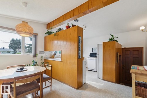 Defined dining area with a woven pendant light fixture - 12835 91 Street Nw, Edmonton, AB - Indoor