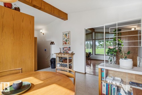 Open-concept living area featuring exposed wood beams and light wood-finish flooring - 12835 91 Street Nw, Edmonton, AB - Indoor Photo Showing Other Room