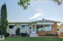 Ranch-style exterior featuring a stucco and brick facade with a wide, arched picture window - 12835 91 Street Nw, Edmonton, AB  - Outdoor 