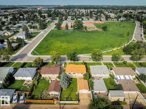 Aerial perspective showcasing a residential neighborhood with detached homes, mature trees, and manicured lawns - 12835 91 Street Nw, Edmonton, AB - Outdoor With View