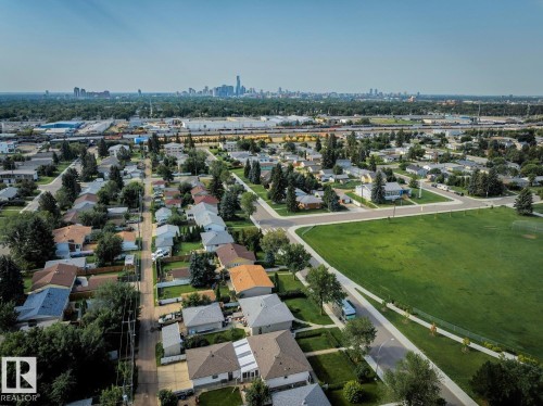 Aerial perspective showcasing a residential neighborhood with a large green space - 12835 91 Street Nw, Edmonton, AB - Outdoor With View