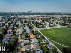 Aerial perspective showcasing a residential neighborhood with a large green space - 