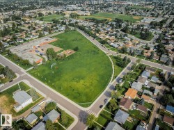 Aerial perspective showcasing a residential area with varied rooflines and established landscaping - 