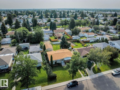 Residential neighborhood featuring mature trees, paved streets, and a mix of single-story homes - 12835 91 Street Nw, Edmonton, AB - Outdoor With View