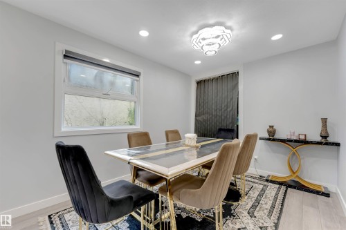 Recessed ceiling lighting complements a contemporary chandelier - 7419 33 Avenue Nw, Edmonton, AB - Indoor