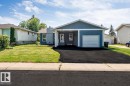 Single-story residence featuring a blue stucco exterior with white trim - 7419 33 Avenue Nw, Edmonton, AB  - Outdoor With Facade 