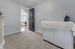Light gray walls with white baseboards frame a textured gray carpet - 