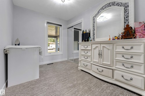 Light gray walls with a white framed window and a patterned gray carpet - 7419 33 Avenue Nw, Edmonton, AB - Indoor